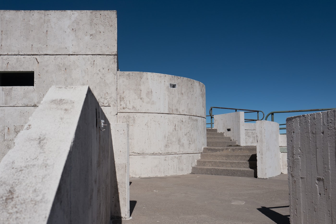 White concrete architecture and a flight of stairs under a blue sky
