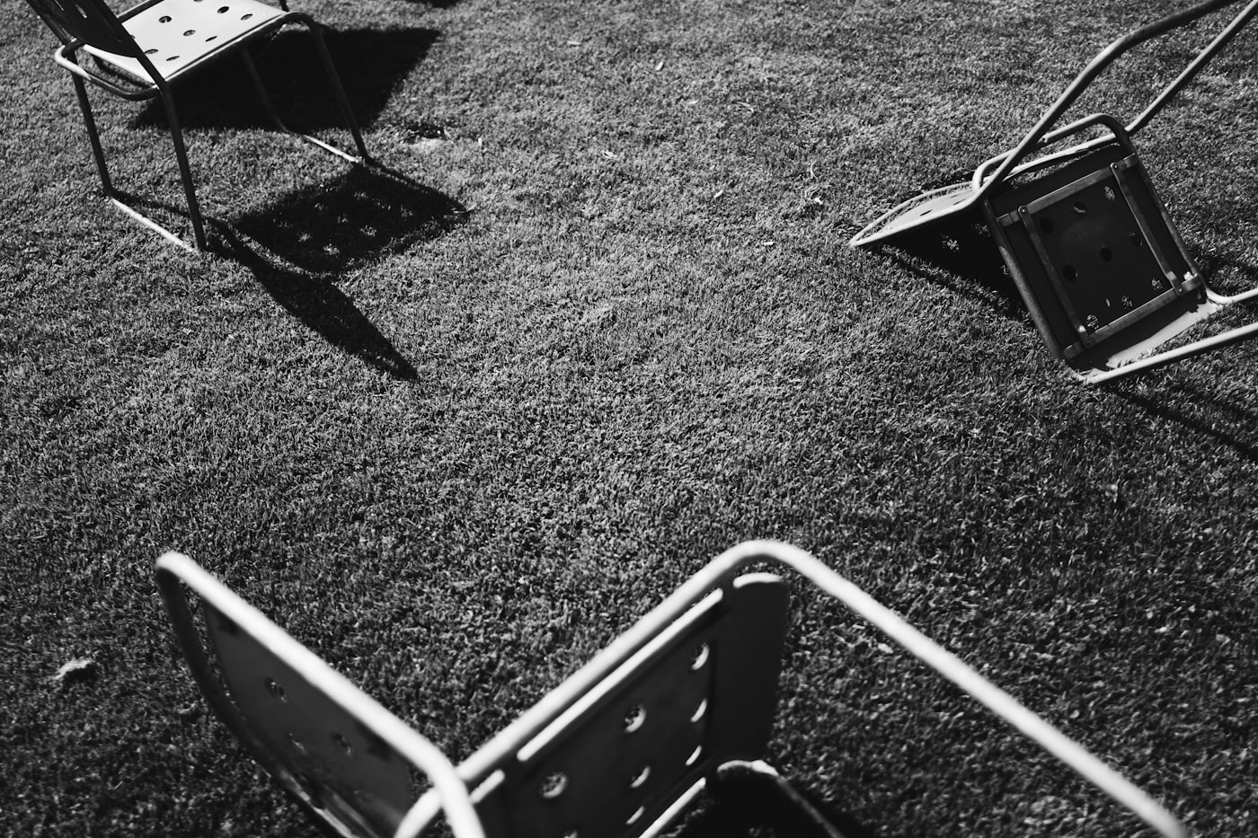Grey chairs on a grass field